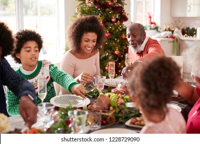 Young Black Woman Eating Christmas Dinner With Her Mixed Race Multi Generation Family, Close Up