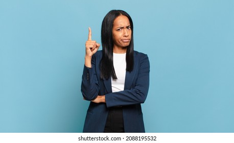 Young Black Woman Feeling Like A Genius Holding Finger Proudly Up In The Air After Realizing A Great Idea, Saying Eureka. Business Concept