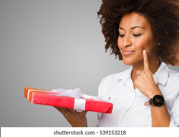 Young Black Woman Holding A Gift