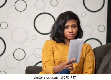 Young Black Woman Holding A Letter Envelope