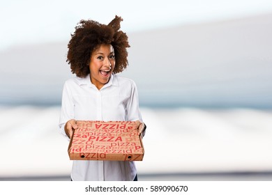 Young Black Woman Holding A Pizza Box