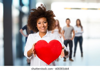 Young Black Woman Holding A Red Heart Shape