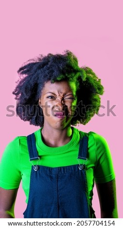 Young black woman isolated grimacing displeased and confused advertising copy space background