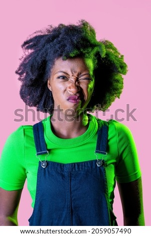 Young black woman isolated grimacing displeased and confused