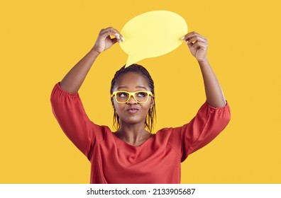 Young Black Woman Isolated On Yellow Studio Background Show Empty Mockup Speech Bubble. Millennial African American Girl Demonstrate Blank Space In Talk Balloon, Recommend Offer Or Deal.