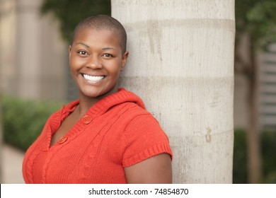 Young Black Woman Leaning On A Tree