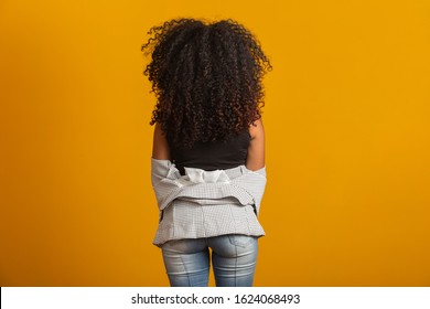 Young Black Woman On Her Back With Afro Hairstyle On White Background. Girl With African Hairstyle. Studio Shot.