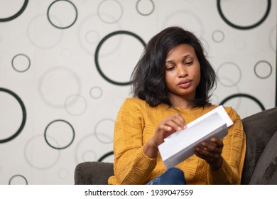 Young Black Woman Opening A Letter Envelope