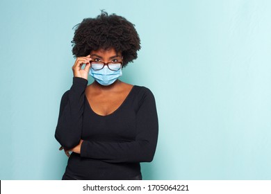 Young Black Woman With Black Power Hair Wearing Protective Mask With Reading Glasses