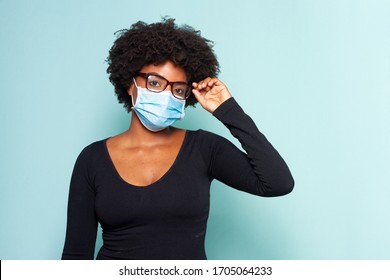 young black woman with black power hair wearing protective mask with reading glasses - Shutterstock ID 1705064233