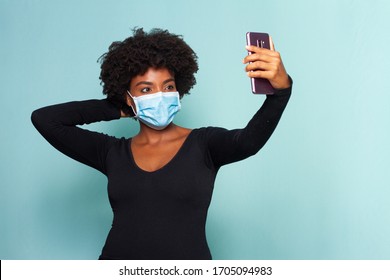 young black woman with black power hair wearing protection mask making a selfie - Shutterstock ID 1705094983