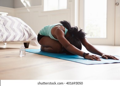 Young Black Woman Practicing Yoga In The Cat Stretch Pose