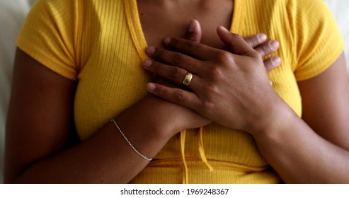 Young Black Woman Putting Hands On Chest With Faith And Hope