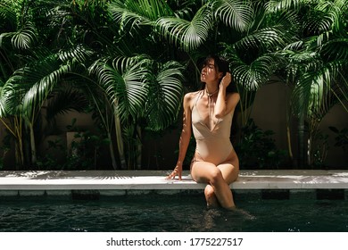 Young black woman relaxing at spa pool. Beautiful woman relaxing in outdoor spa swimming pool. Closeup face of attractive girl with closed eyes enjoy vacation at resort.