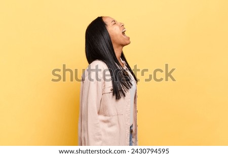 young black woman screaming furiously, shouting aggressively, looking stressed and angry