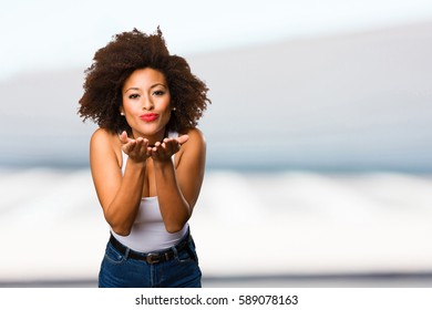 young black woman sending kisses