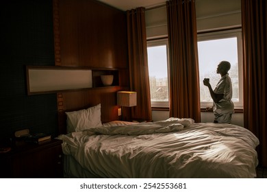 A young black woman with a shaved head waking leisurely up on a bright sunny morning - Powered by Shutterstock