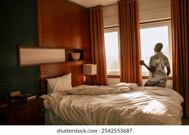 A young black woman with a shaved head waking leisurely up on a bright sunny morning - Powered by Shutterstock