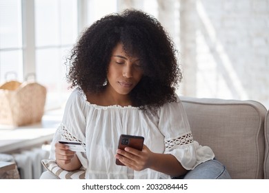 Young Black Woman Spending Money In Internet Websites And Stores And Making Online Payments. Female African Blogger Buying Clothes And Beauty Products. Purchasing Concept.