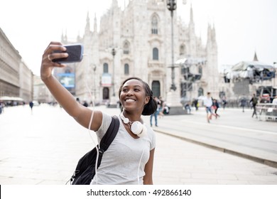 Young Black Woman Taking Selfie With Smart Phone Hand Hold With Milan Cathedral In Background, Smiling - Happiness, Traveler, Technology Concept