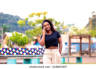 Young Black Woman Talking On Cell Phone In City Square. Making A Phone Call.