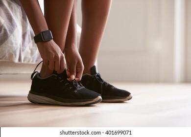 Young Black Woman Tying Sports Shoes, Close-up