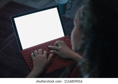 Young Black Woman Typing On Laptop Computer At Night. Over The Shoulder Shot Of Screen And Blank Monitor For Mock-up