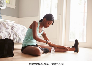 Young Black Woman Using Smart Watch While Exercising At Home