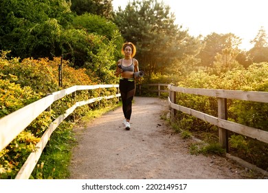 Young Black Woman Walking With Yoga Mat After Practice In Summer Park Outdoors