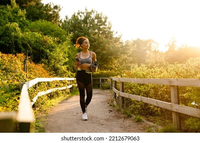 Young Black Woman Walking With Yoga Mat After Practice In Summer Park Outdoors