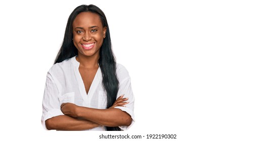 Young black woman wearing casual clothes happy face smiling with crossed arms looking at the camera. positive person. 