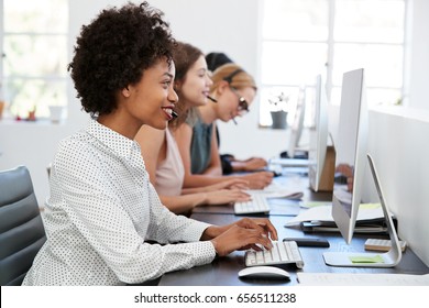 Young Black Woman Working At Computer In Office With Headset