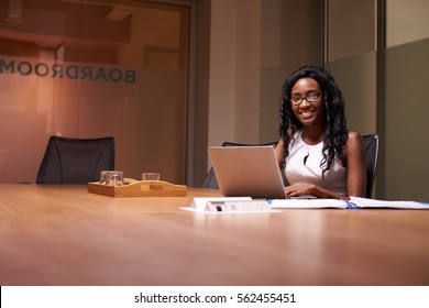 Young Black Woman Working Late In Office Smiling To Camera