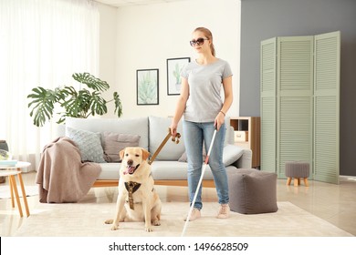 Young Blind Woman With Guide Dog At Home