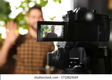 Young Blogger Recording Video Indoors, Focus On Camera Screen