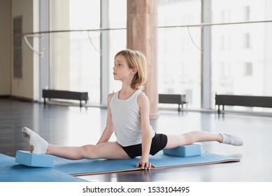 Young blond ballet boy stretching.  