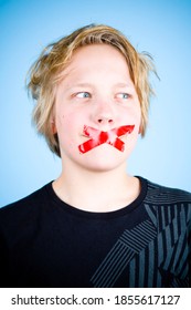 Young Blond Boy Muted, Silenced With Red Tape Over Mouth.