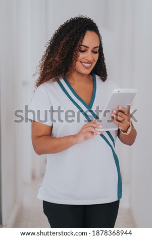 Young blond Caucasian female opening her mouth while African-American ethnic dentist in white latex gloves check condition of her teeth focus on dentist