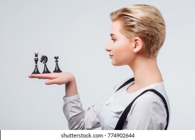 Young Blond Female Chess Player Holding Chess Hands In Profile Isolated On White Background