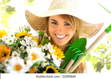young blond girl with gardening tools