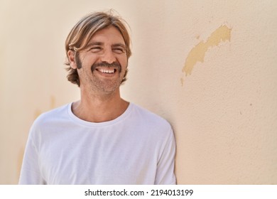 Young Blond Man Smiling Confident Looking To The Side At Street