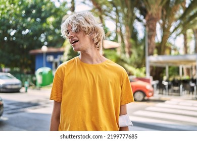 Young Blond Man Smiling Confident Looking To The Side At Street