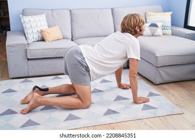 Young Blond Man Stretching Back At Home