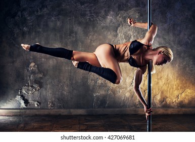 Young Blond Sexy Pole Dance Woman On Old Wall Background