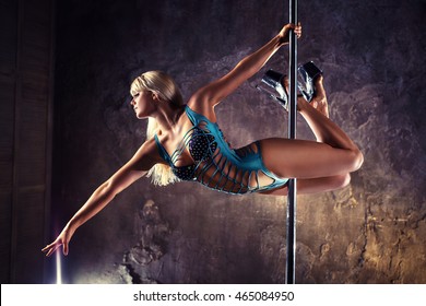 Young Blond Sexy Pole Dance Woman On Old Wall Background