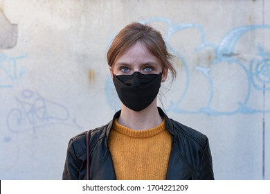 Young Blond Woman With Big Blue Eyes Wearing Black Protective Facemask, People In Face Masks