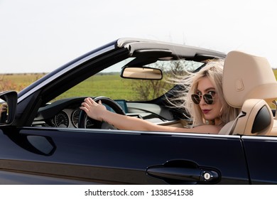 young blond woman in the car - Powered by Shutterstock