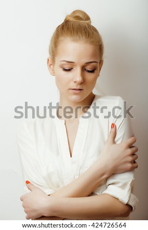 young blond woman emotional in studio isolated gesturing, making goofy faces, lifestyle people concept