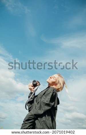 Similar – Blonde woman with black dress and sunglasses performing dance in nature with backlight