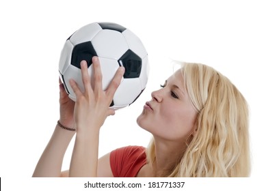 young blond woman kissing soccer ball